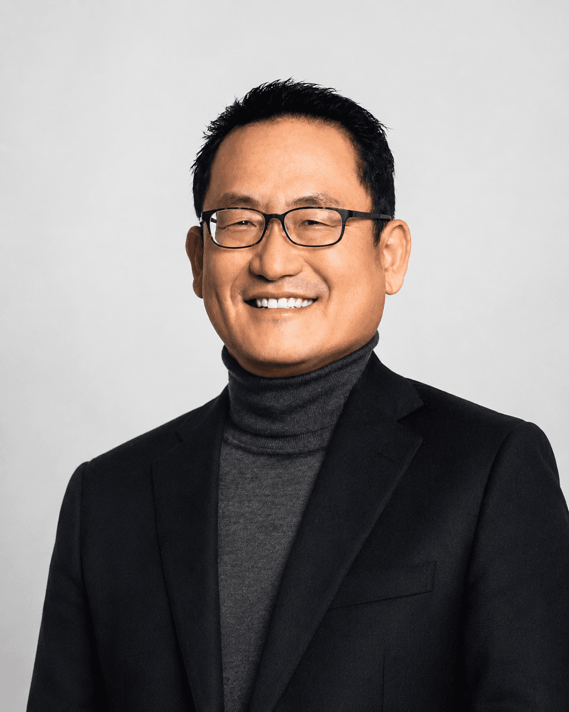 Steve Kim, licensed insurance broker and founder of WFI Healthcare Agency, smiling in a dark blazer against a light studio backdrop